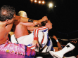 Rudo misterioso tries to help partner Gringo Loco as he is being decimated by Hijo de Santo.